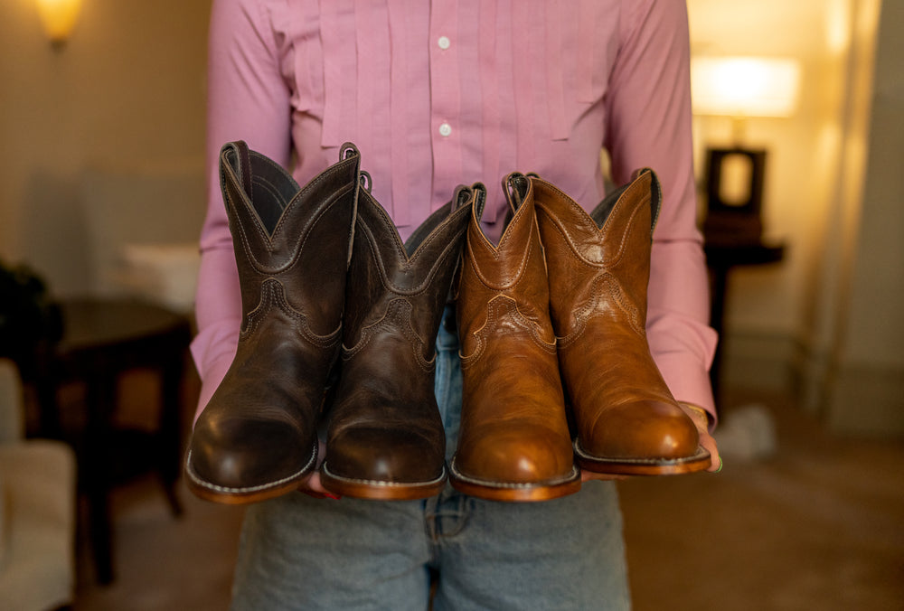 
                  
                    Man Holding Fargo Chocolate color and Bourbon color peace boots
                  
                