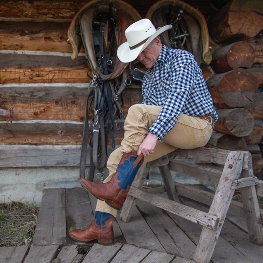 
                  
                    putting on a stockman cowboy boot
                  
                