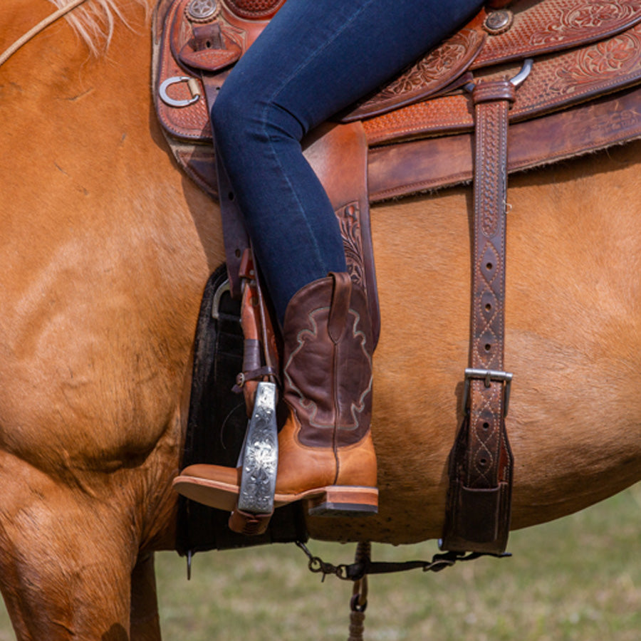 
                  
                    Woman on Horse wearing a two tone western boot
                  
                